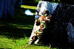 Airman 1st Class Andrew Bradley , 628th Civil Engineer Squadron firefighter, fires his paintball gun during a match against defenders from the 628th Security Forces Squadron during the "Guns and Hoses" fitness challenge, May 15, 2012 at Joint Base Charleston, S.C. The 628th SFS hosted the firefighters in a day full of competition known as the "Guns and Hoses" fitness challenge. The competition included a paintball match, defender ball and a softball game. The event kicked off National Police Week, which occurs annually during the week of May 15. It recognizes the service and sacrifice of U.S. law enforcement personnel. (U.S. Air Force photo/Staff Sgt. Nicole Mickle)