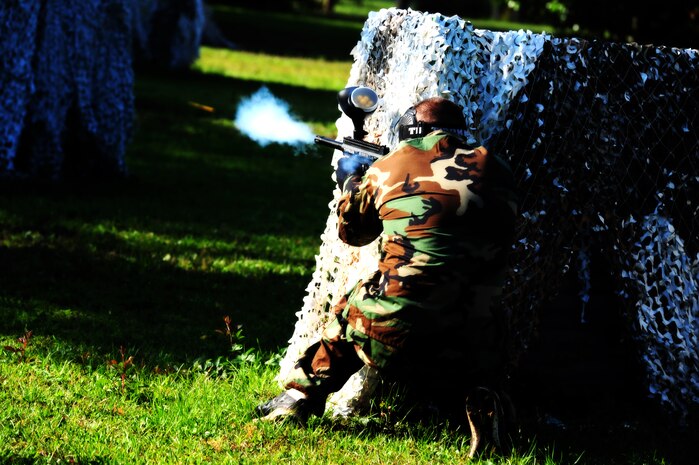 Airman 1st Class Andrew Bradley , 628th Civil Engineer Squadron firefighter, fires his paintball gun during a  match against defenders from the 628th Security Forces Squadron during the "Guns and Hoses" fitness challenge, May 15 at Joint Base Charleston - Air Base, S.C.  The 628th SFS hosted the firefighters in a day full of competition known as the "Guns and Hoses" fitness challenge.  The competition included a paintball match, defender ball and a softball game.  The event kicked off National Police Week, which occurs annually during the week of May 15.  It recognizes the service and sacrifice of U.S. law enforcement personnel.  (U.S. Air Force photo/ Staff Sgt. Nicole Mickle)  