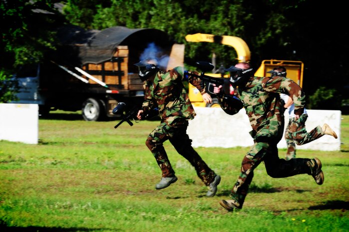 Firefighters from the 628th Civil Engineer Squadron take off during a paintball match against defenders from the 628th Security Forces Squadron during the "Guns and Hoses" fitness challenge, May 15 at Joint Base Charleston - Air Base, S.C.  The 628th SFS hosted the firefighters in a day full of competition known as the "Guns and Hoses" fitness challenge.  The competition included a paintball match, defender ball and a softball game.  The event kicked off National Police Week, which occurs annually during the week of May 15.  It recognizes the service and sacrifice of U.S. law enforcement personnel.  (U.S. Air Force photo/ Staff Sgt. Nicole Mickle)  