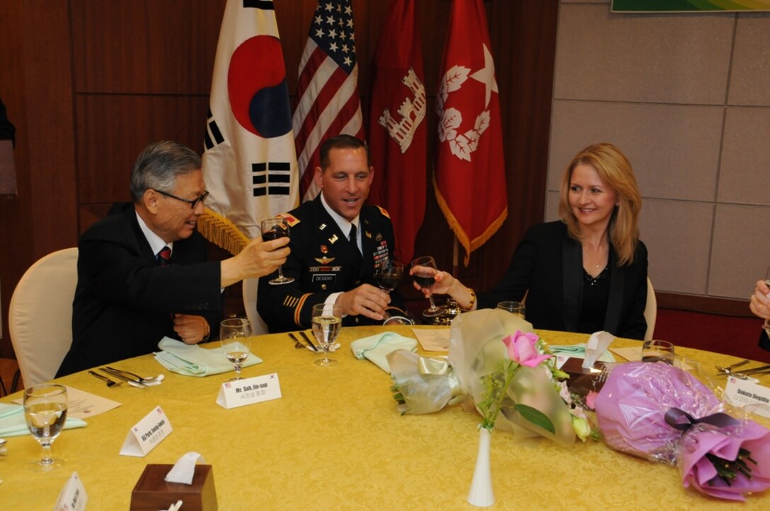 SEOUL, Korea — Suh Jin-Sup (left), Chairman of the ROK-U.S. Alliance Friendship Association, Col. Donald E. Degidio, Jr., Commander of the U.S. Army Corps of Engineers Far East District, and Degidio’s wife, Donna, toast during Degidio’s Korean naming ceremony May 10 at the Korea Ministry of National Defense.  
