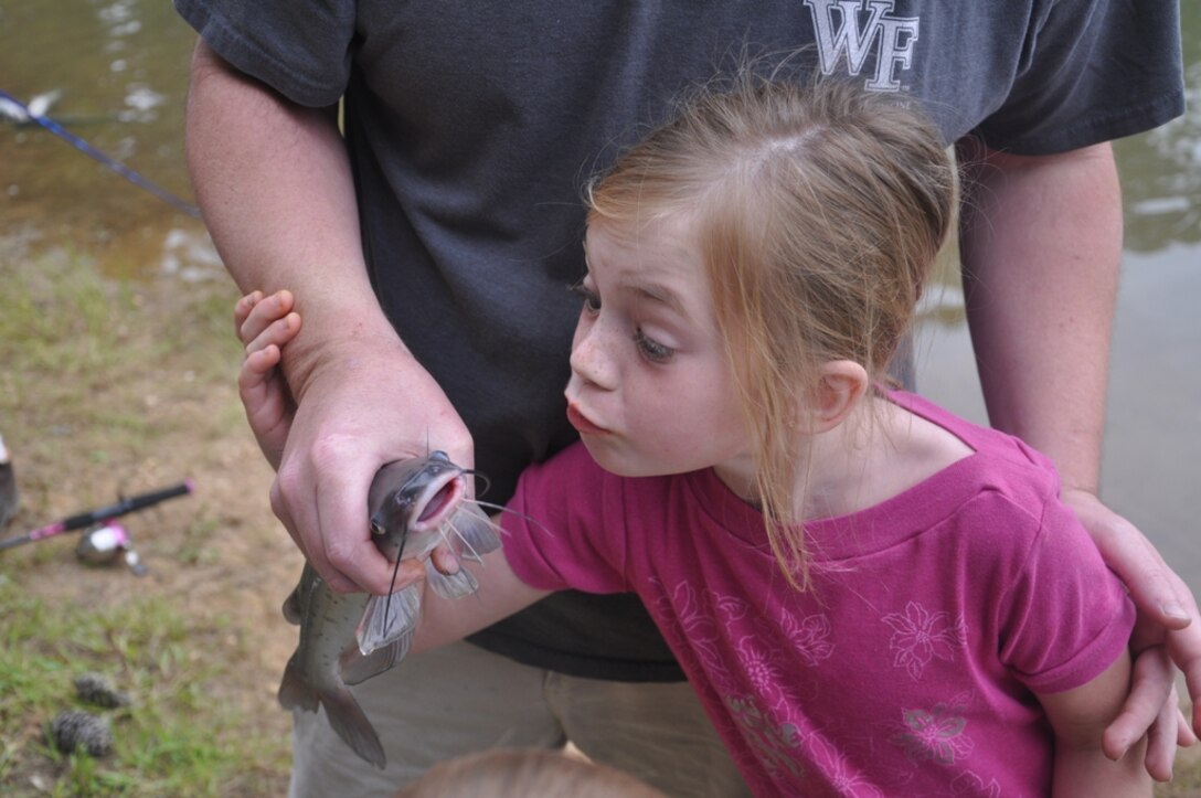 CALHOUN FALLS, S.C. — Elizabeth Dove of Calhoun Falls, S.C., has some fun after catching a catfish at the 24th Annual Kid's Fishing Derby at Richard B. Russell Lake, May 12, 2012.