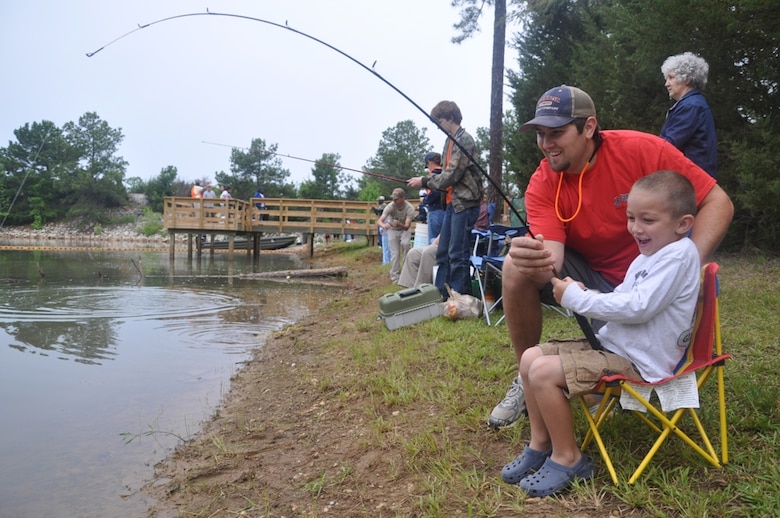 CALHOUN FALLS, S.C — Reuben Overholt of Abbeville, S.C., helps his son, Benjamin, reel in a catfish at the 24th Annual Kid's Fishing Derby at Richard B. Russell Lake, May 12, 2012.