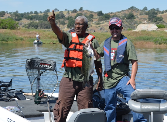 CALIFORNIA — A veteran and a local volunteer showoff their catch during the "Take a Warrior Fishing" event at Eastman Lake, Calif., May 12, 2012. The event was the first of its kind for the U.S. Army Corps of Engineers Sacramento District.