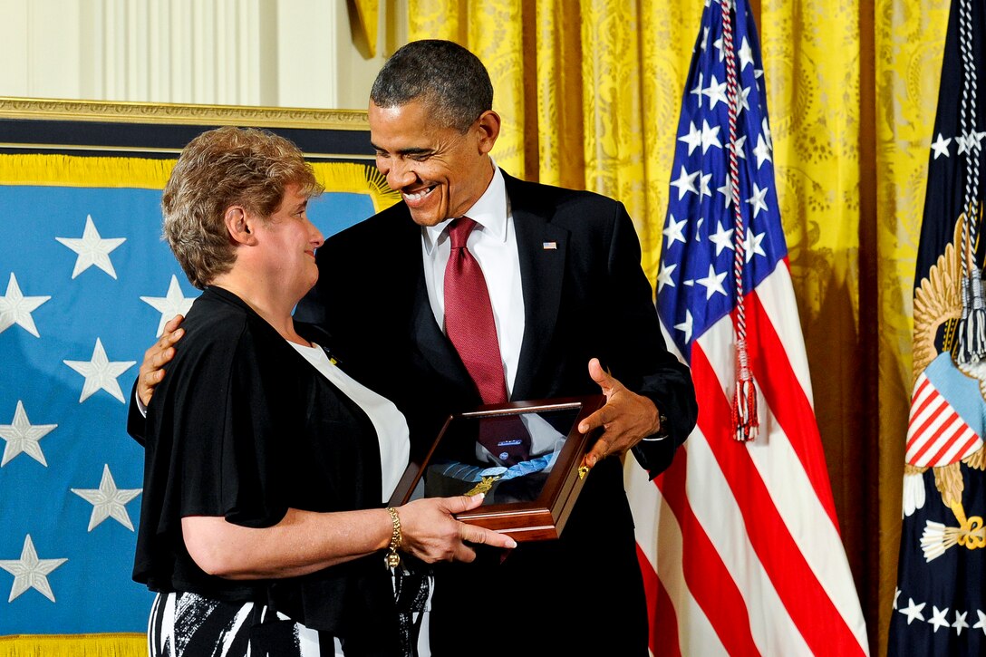 President Barack Obama smiles after he awards the Medal of Honor posthumously to Army Spc. 4 Leslie H. Sabo Jr. and presents it to Sabo's widow, Rose Mary Sabo-Brown, during a ceremony at the White House in Washington, D.C., May 16, 2012. Sabo was killed in action in Cambodia in 1970 while saving the lives of fellow soldiers during the Vietnam War.