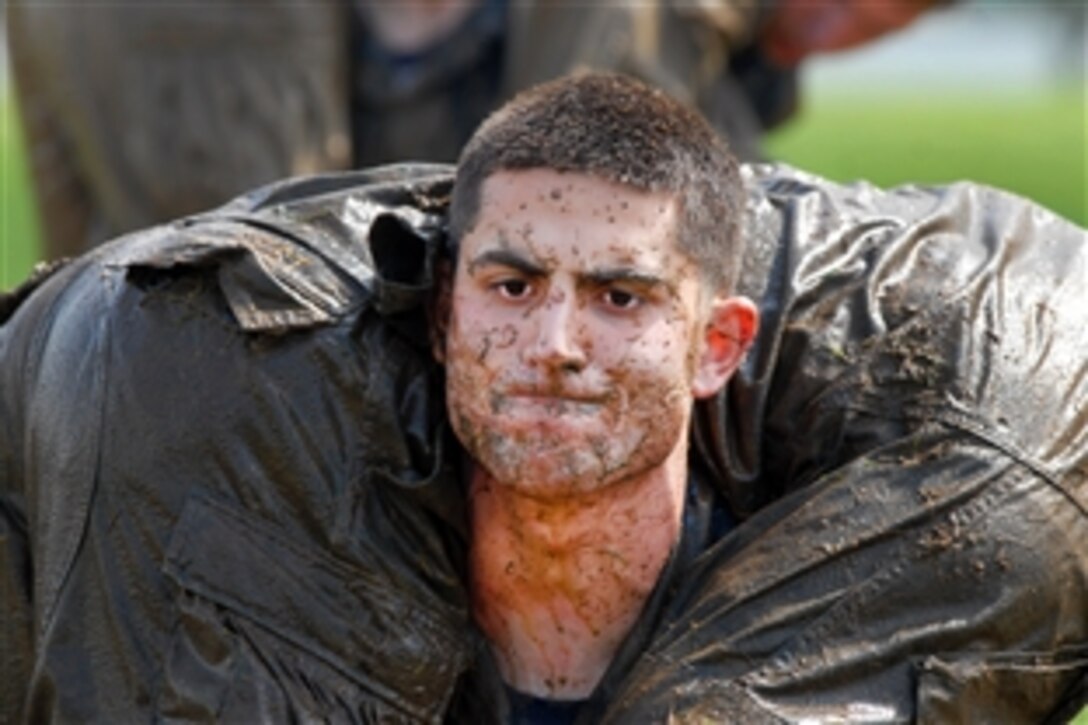 A U.S. Naval Academy freshman, or plebe, carries his classmate during the academy's annual Sea Trials in Annapolis, Md., May 15, 2012. The endurance exercise for the academy's freshmen also serves as a leadership challenge for upper classmen, who direct each event.