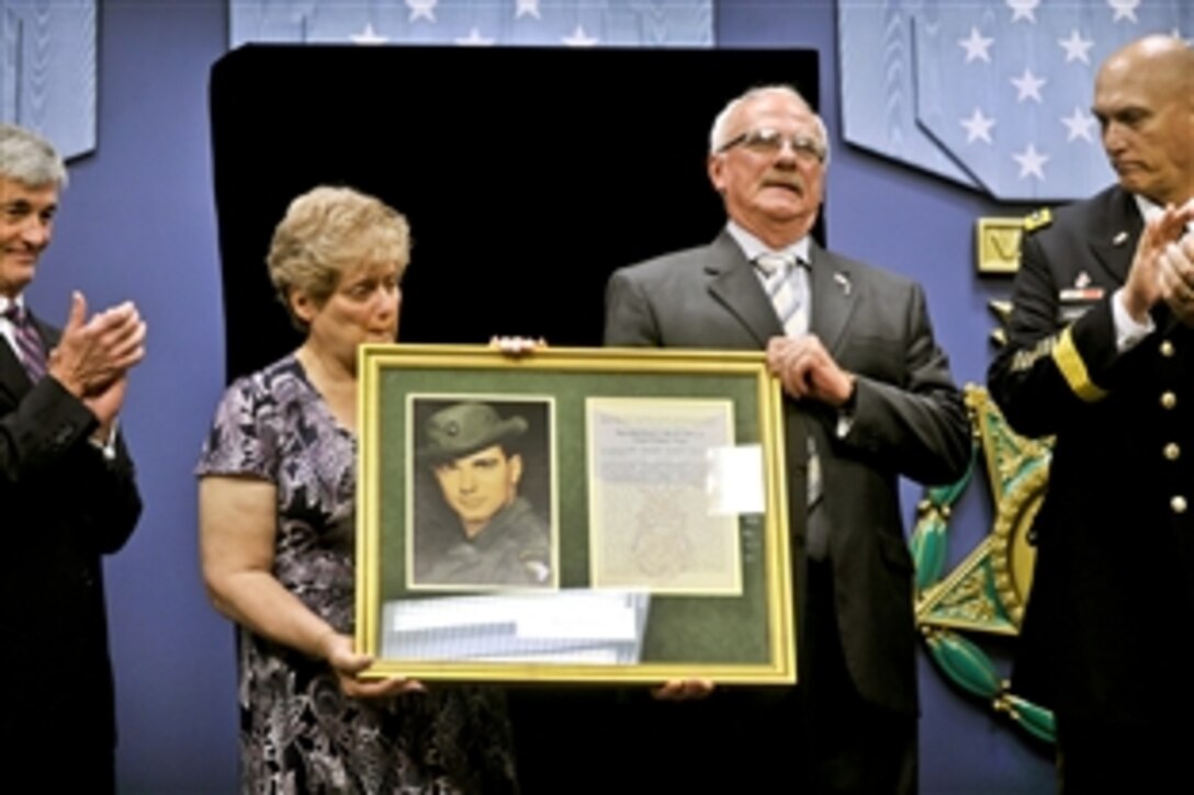 Rose Mary Sabo-Brown, widow of Medal of Honor recipient Army Spc. 4 Leslie H. Sabo Jr., and George Sabo, Sabo's brother, receive a framed picture and letter honoring Sabo as defense leaders posthumously induct the Vietnam-era soldier into the Hall of Heroes at the Pentagon, May 17, 2012. Army Secretary John M. McHugh, far left, and Army Chief of Staff Gen. Ray Odierno participated in the ceremony.