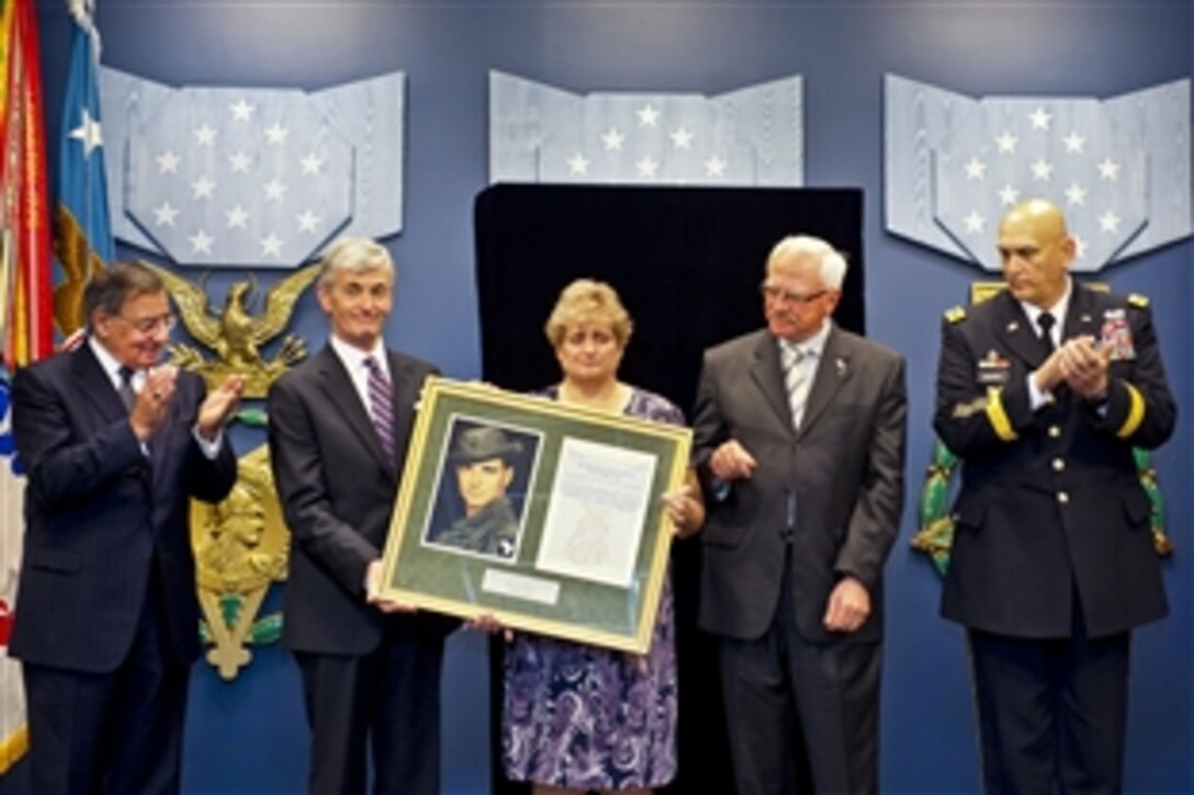 Defense Secretary Leon E. Panetta, far left, Army Secretary John M. McHugh and Army Chief of Staff Ray Odierno present a framed photo and the award citation to Rose Mary Sabo-Brown, widow of Medal of Honor recipient Army Spc. 4 Leslie H. Sabo Jr., and George Sabo, Sabo's brother, during a ceremony to induct the Vietnam-era soldier into the Hall of Heroes at the Pentagon, May 17, 2012.