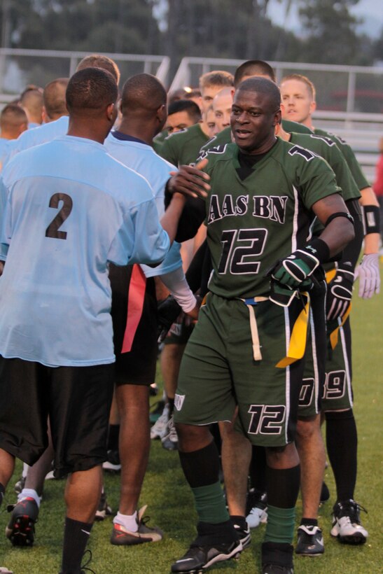 The Combat Logistics Regiment 17 Desk Jockeys and Assault Amphibious School Battalion Gators shake hands after the game during the 2012 Flag Football Championship League on Camp Pendleton, May 17. As the game ended, the name of the winner was announced along with the presentation of trophies and medals.