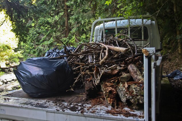 Marine Aviation Logistics Squadron 12 and Headquarters and Headquarters Squadron Marines worked together to gather wood, brush and trash at the Futashika River, May 18. The Marine Lounge hosted the river cleanup and together volunteers and workers gathered two truck loads of wood and approximately 20 bags of trash and brush.