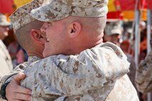 Sgt. Maj. Micheal P. Barrett, sergeant major of the Marine Corps, hugs Sgt. Maj. William F. Squires, former Marine Corps Air Station New River sergeant major, after his relief and appointment, and retirement ceremony aboard the air station, May 4. Squires passed the Sword of Office to the oncoming sergeant major, Sgt. Maj. Robert A. Allen. 