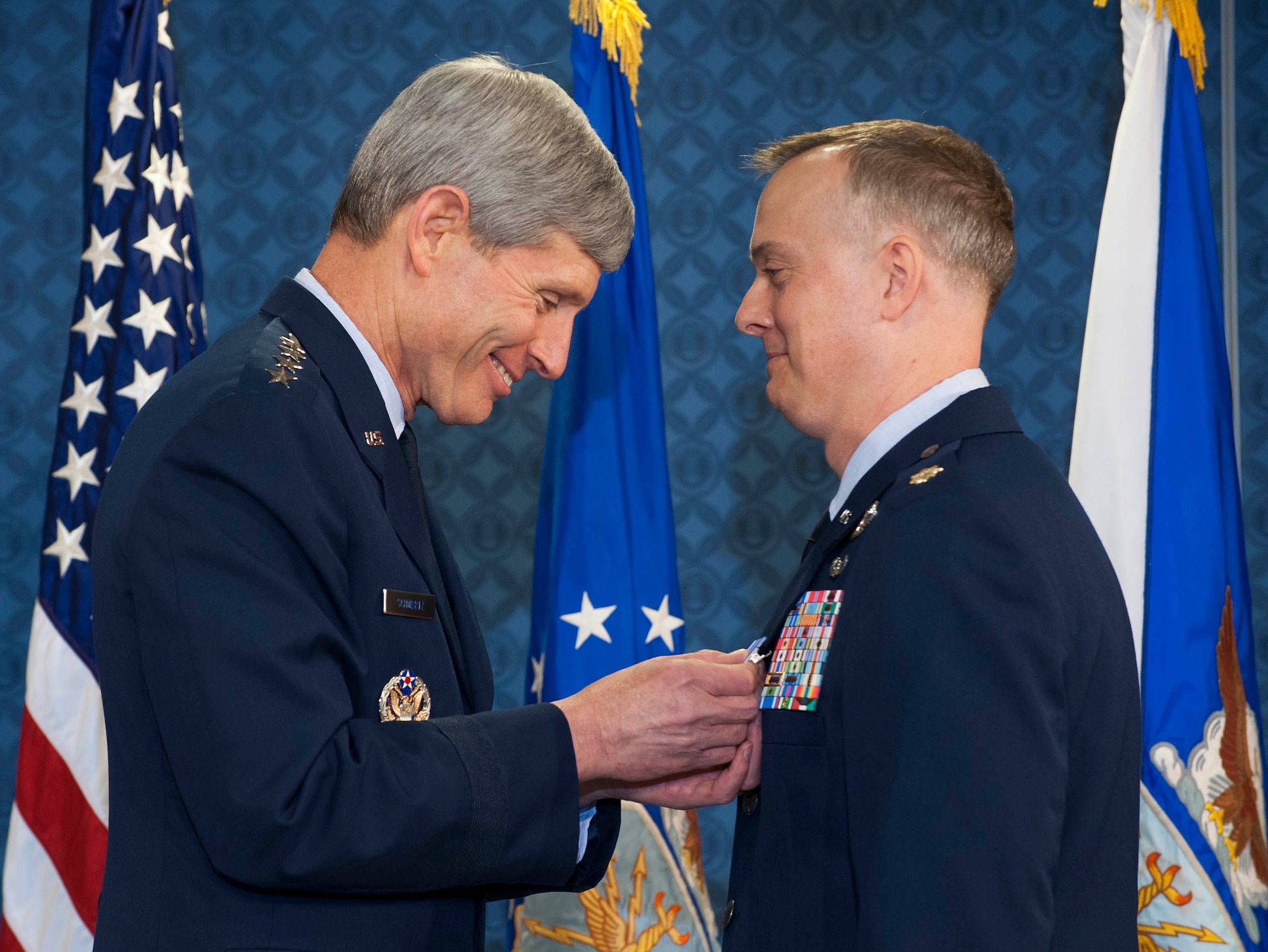 Air Force Chief of Staff Gen. Norton Schwartz (left) presents the first of two Distinguished Flying Cross with Valor medals to Maj. John Creel during a ceremony in the Pentagon on May 18, 2012. (U.S. Air Force photo/Jim Varhegyi)
