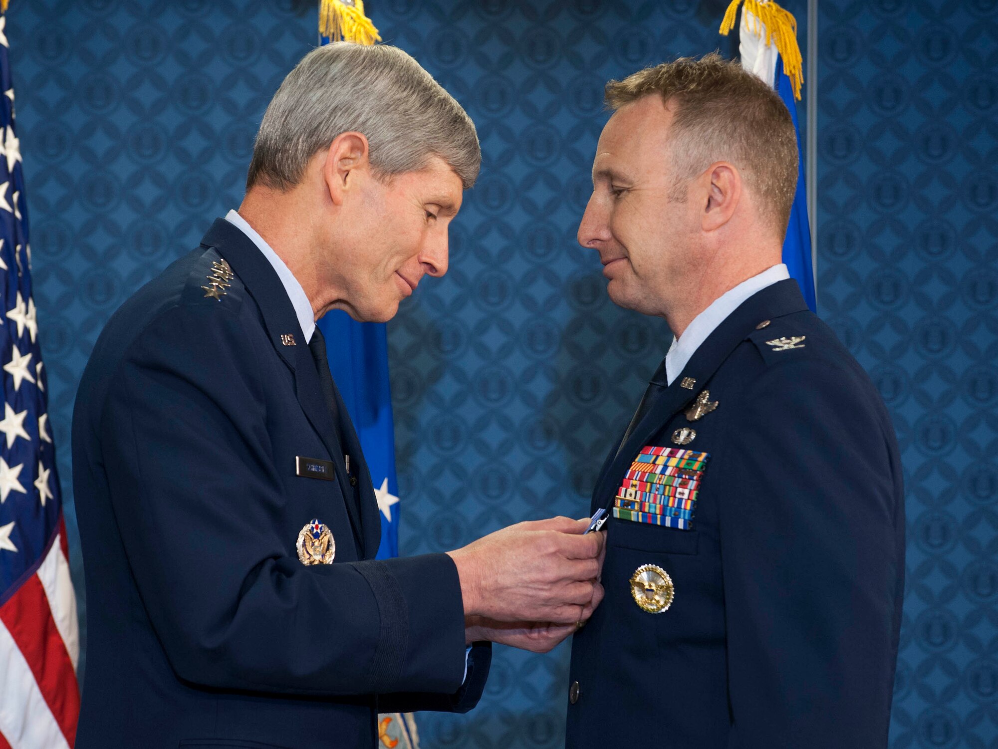 Air Force Chief of Staff Gen. Norton Schwartz (left) presents the first of two Distinguished Flying Cross with Valor medals to Col. Christopher Barnett during a ceremony in the Pentagon on May 18, 2012.  Barnett also received the Bronze Star during the ceremony.  (U.S. Air Force photo/Jim Varhegyi)
