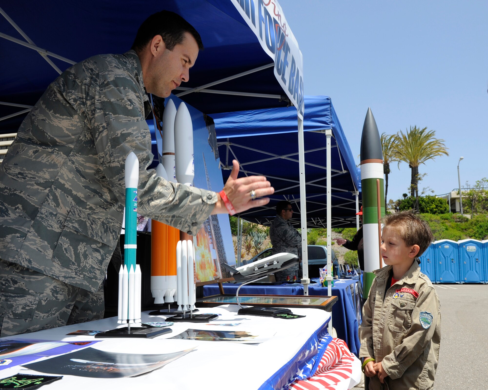 TORRANCE, Calif. --Capt. Michael May, a 30th Operations Group deputy chief of standardization and evaluation, talks about the Delta IV rocket with Marcel Blake, a four-year old Torrance native, during the 53rd Annual Armed Forces Day here Friday, May 18, 2012. Military displays varied from rockets to tanks and were open for the public. (U.S. Air Force photo/Staff Sgt. Levi Riendeau) 

 
 