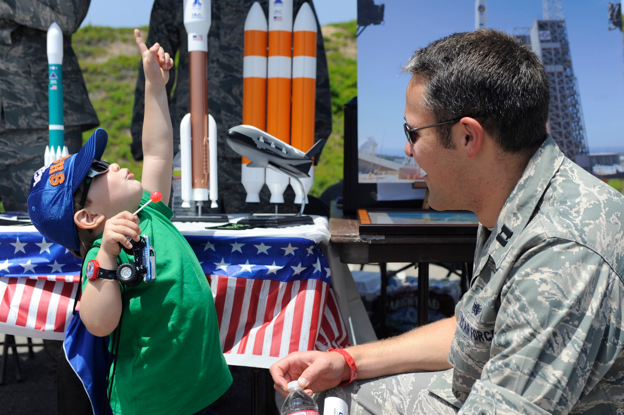 TORRANCE, Calif. -- Ayden Meyn, a two-year old Torrance native, learns about rockets with Capt. Pierre Gregoire, a 2nd Range Operations Squadron mission flight control officer, during the 53rd Annual Armed Forces Day here Friday, May 18, 2012. Military displays varied from rockets to tanks and were open for the public. (U.S. Air Force photo/Staff Sgt. Andrew Satran) 
