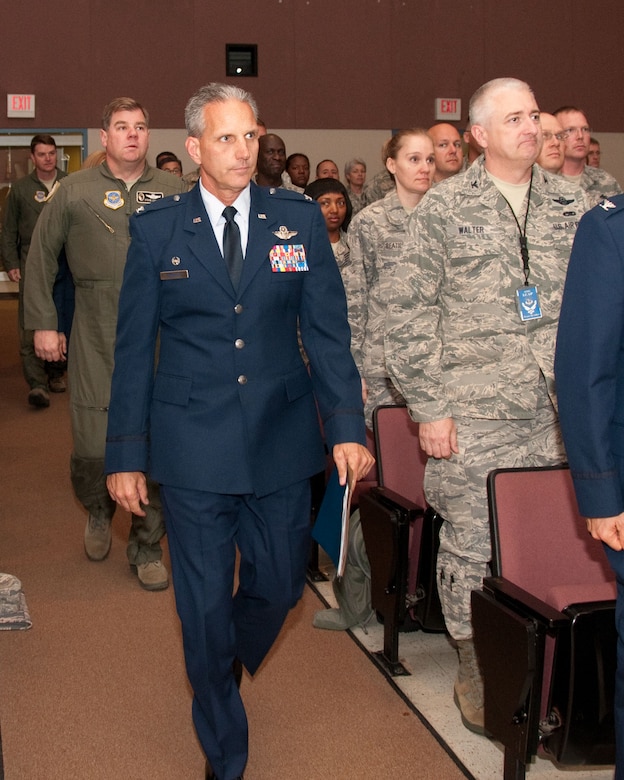 Members of the 146th Airlift Wing stand at attention for the arrival of Col. Paul Hargrove,146th Airlift Wing  Wing Commander, and Compliance Inspection Team Chief  Col. Steven Legrand. The 146th Airlift Wing held an in-briefing May 18 for the Compliance Inspectionto be held throughout the weekend. (U.S. Air Force photo by: Senior Airman Nicholas Carzis)