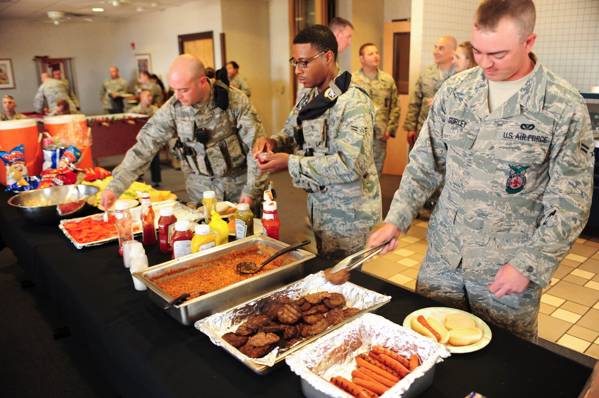 Air Commandos from the 27th Special Operations Security Forces Squadron and 27th Special Operations Civil Engineer Squadron fill their plates with hamburgers and hotdogs at a cookout during Police Week at Cannon Air Force Base, N.M., May 16, 2012. In honor of National Police Week, the fire protection flight sponsored a barbeque for the Cannon’s law enforcement. (U.S. Air Force photo by Airman 1st Class Eboni Reece)