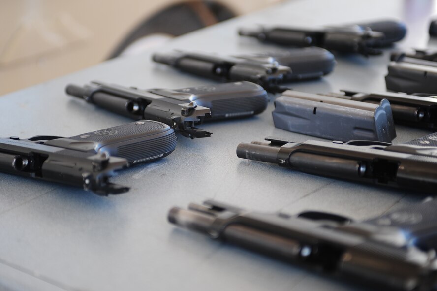 M9 weapons from the Cannon Air Force Base, N.M. Combat Arms Training and Maintenance were available for use during the pistol shoot competition at the Clovis Police Department shooting range in Clovis, N.M., May 15, 2012. This event was organized by the 27th Special Operations Security Forces Squadron in honor of National Police Week. (U.S. Air Force photo by Airman 1st Class Eboni Reece)