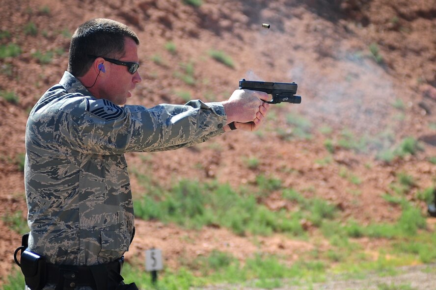 U.S. Air Force Master Sgt. Clayton Regan, 27th Special Operations Security Forces Squadron, fires his weapon during the pistol shoot competition at Clovis Police Department shooting range in Clovis, N.M., May 15, 2012. This event was organized by the 27 SOSFS in honor of National Police Week. (U.S. Air Force photo by Airman 1st Class Eboni Reece)