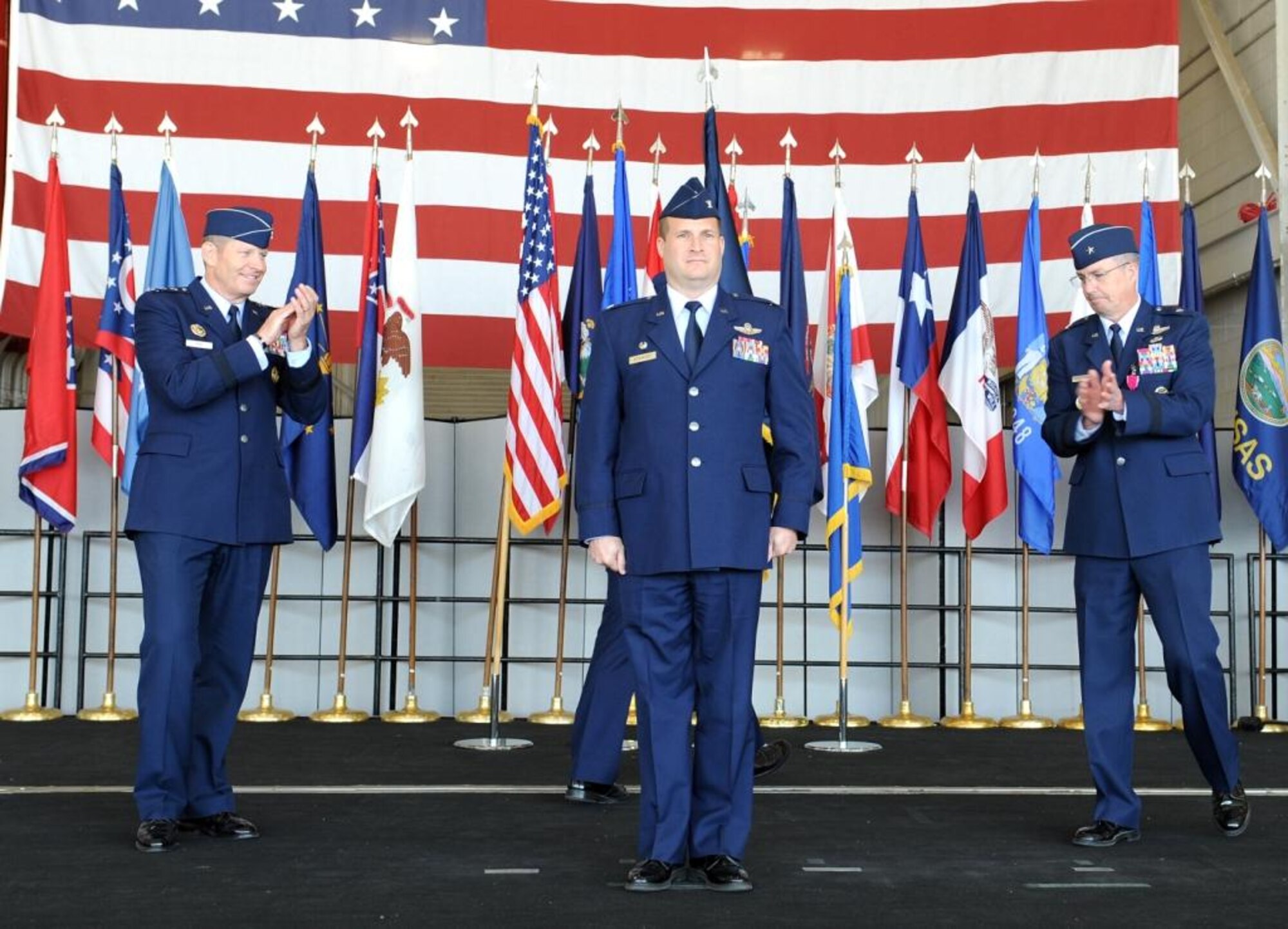 Col. Phil Stewart (center), the newest 9th Reconnaissance Wing commander is congratulated by Lt. Gen. Robin Rand (left), 12th Air Force commander and out-going 9 RW commander, Brig. Gen. Paul McGillicuddy (right) during a change of command ceremony at Beale Air Force Base Calif., May 10, 2012. Rand was the presiding official for the event.  (U.S. Air Force photo by John Schwab/Released)