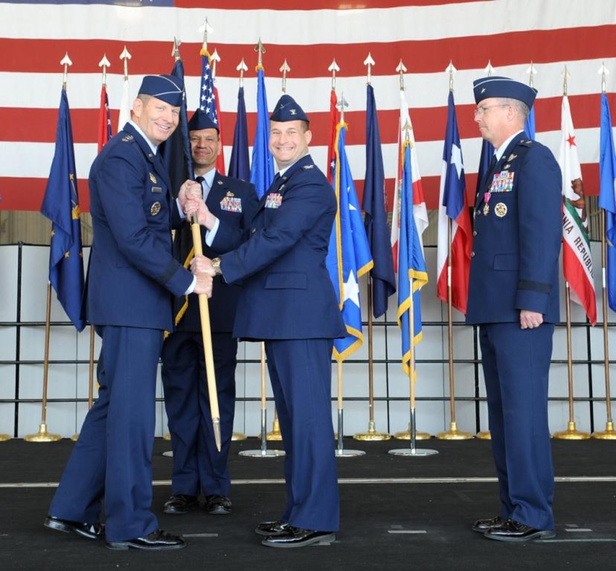 Lt. Gen. Robin Rand, 12th Air Force commander, presents the newest 9th Reconnaissance Wing commander Col. Phil Stewart with the wing’s guidon during a change of command ceremony at Beale Air Force Base Calif., May 10, 2012. Stewart severed as the wing’s vice commander prior to taking command from Brig. Gen. Paul McGillicuddy (right). (U.S. Air Force photo by John Schwab/Released)