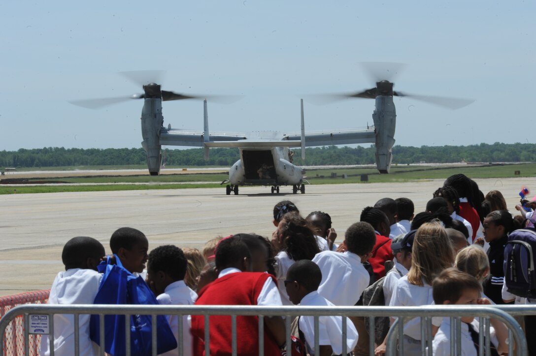 A U.S. Marine Corps MV-22 Osprey taxies past a corral of young students at Joint Base Andrews, May 18. This year’s Joint Service Open House (JSOH) celebrates the Centennial of Marine Corps Aviation. JSOH affords the public an opportunity to meet the men and women of the Armed Forces while seeing over 100 static displays and 19 aerial demonstration teams. (U.S. Air Force photo/Airman 1st Class Aaron Stout)


