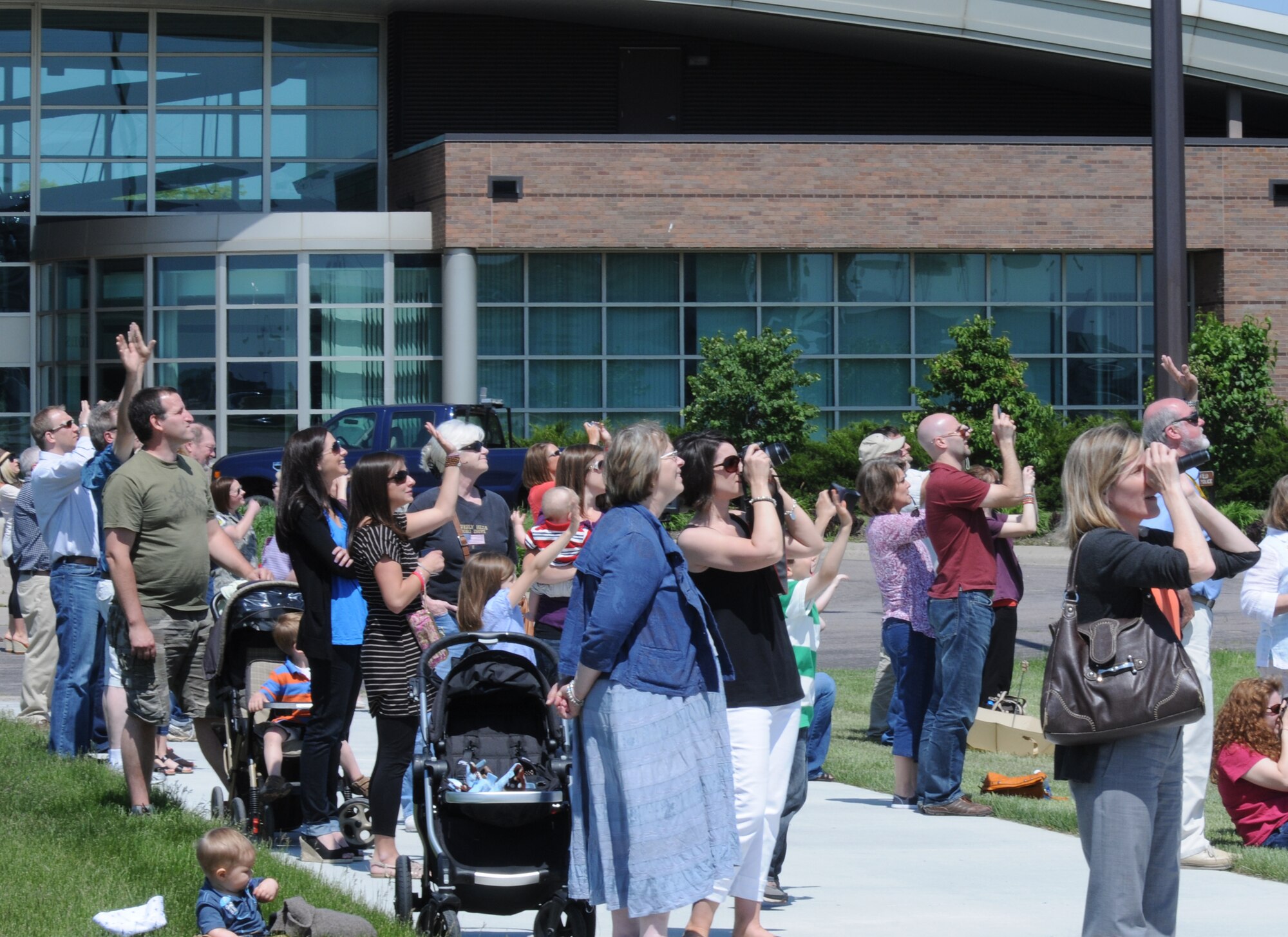 Family and friends of Airmen wave as a Minnesota Air National Guard C-130 performs a fly-by overhead at the Minneapolis- St. Paul International Airport on May 16, 2012, returning from a deployment to Southwest Asia. USAF official photo by Senior Master Sgt. Mark Moss