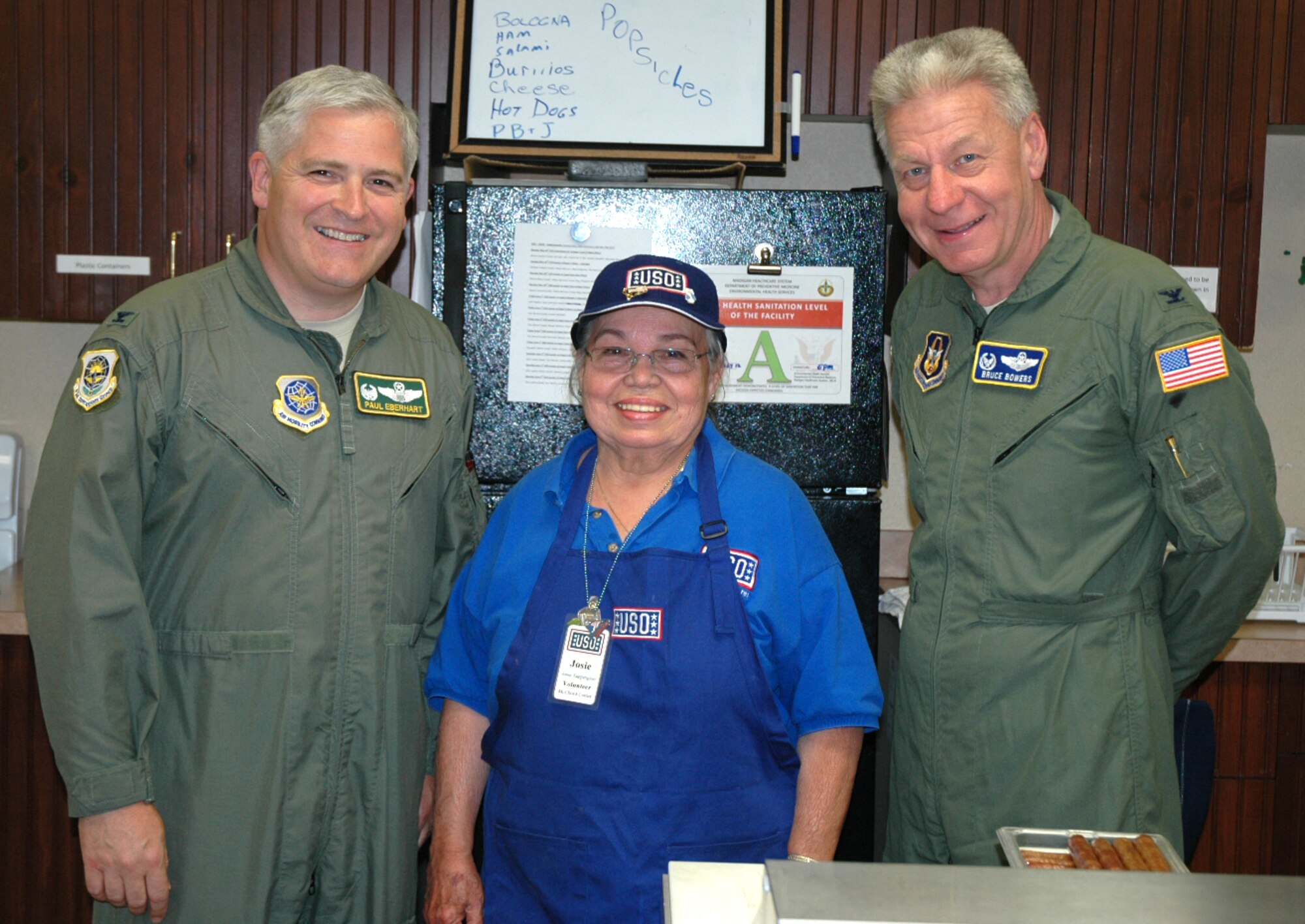Col. Paul Eberhart, 62nd Operations Group commander, left, and Col. Bruce Bowers, 446th Airlift Wing commander, stopped by the USO Shali Center at McChord Field May 17 to thank volunteers, like Josie Sappington, for their support. Airmen from the 446th and 62nd AWs deploying to Turkey today were able to use the center enjoying the food, places to sit and watch TV, play XBOX and do last minute Facebook updates on the computers offered. (U.S. Air Force photo by Sandra Pishner)
