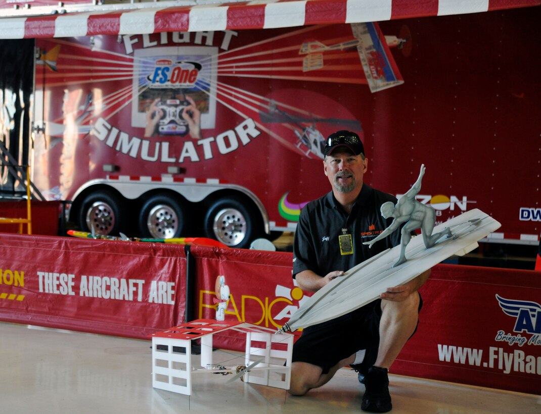 Michael Farlow, a Radio Active Airshows (RAA) employee and radio-controlled aircraft enthusiast, showcases two of RAA’s electric, foam-model novelty-act aircraft inside Hangar 3 on the Joint Base Andrews flightline May 18. This year's Joint Service Open House celebrates the Centennial of Marine Corps Aviation.  JSOH affords the public an opportunity to meet the men and women of the Armed Forces while seeing over 100 static displays and 19 aerial demonstration teams May 18-20 at Joint Base Andrews, Md. (U.S. Air Force photo/Senior Airman Lindsey A. Porter)