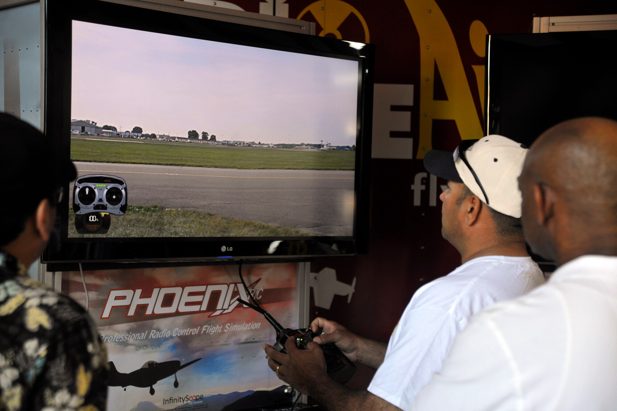 Guests attending the 2012 Joint Service Open House and Air Show take time to visit Radio Active Airshow’s flight simulator inside Hangar 3 on Joint Base Andrews flightline May 18. This year's JSOH celebrates the Centennial of Marine Corps Aviation.  JSOH affords the public an opportunity to meet the men and women of the Armed Forces while seeing over 100 static displays and 19 aerial demonstration teams May 18-20 at Joint Base Andrews, Md. (U.S. Air Force photo/Senior Airman Lindsey A. Porter)