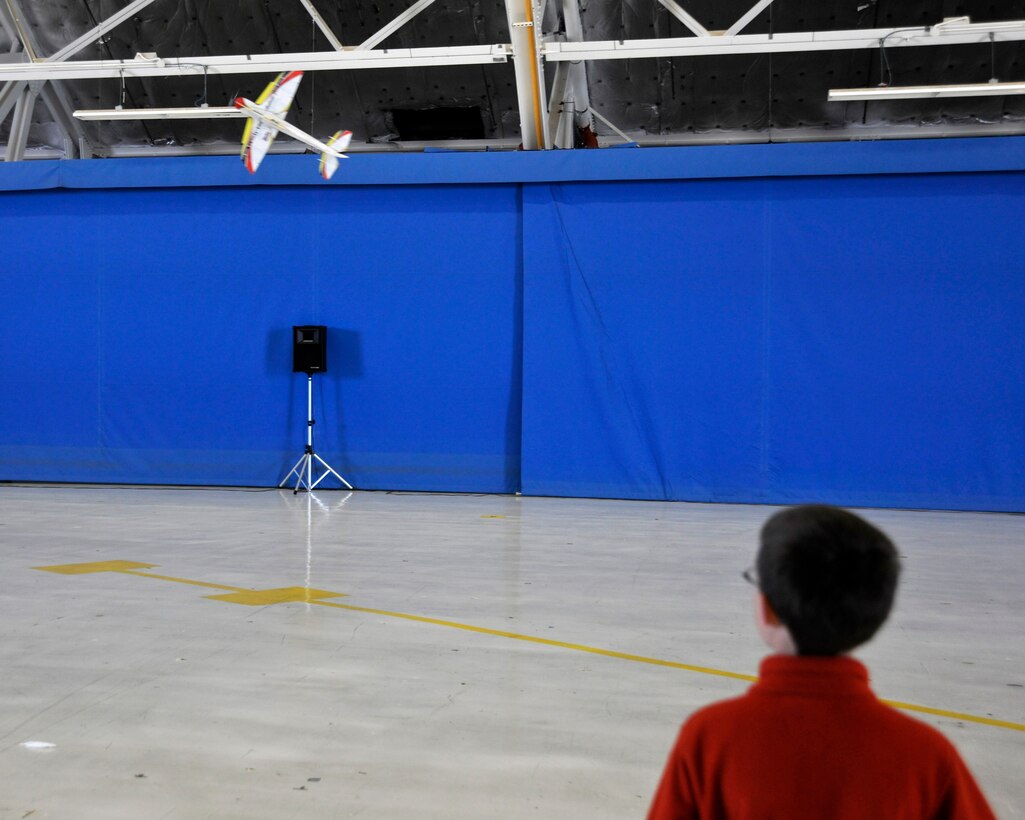 Justin Crews, 12, son of Lin Crews, Radio Active Airshows (RAA) employee and radio-operated aircraft enthusiast, flies an RAA electric foam model aircraft inside Joint Base Andrews’ Hangar 3 during the 2012 Joint Service Open House and Air Show on May 18. This year's JSOH celebrates the Centennial of Marine Corps Aviation.  JSOH affords the public an opportunity to meet the men and women of the Armed Forces while seeing over 100 static displays and 19 aerial demonstration teams May 18-20 at Joint Base Andrews, Md. (U.S. Air Force photo/Senior Airman Lindsey A. Porter)