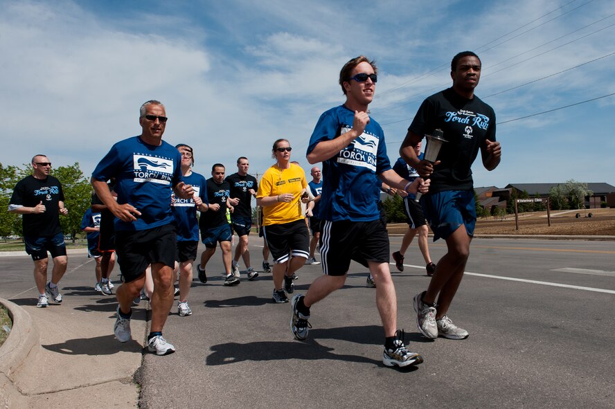 Airmen of the 28th Mission Support Group and two contestants in the upcoming Special Olympics team up with law enforcement officers from around the state run during the South Dakota leg of the Law Enforcement Torch Run on Ellsworth Air Force Base, S.D., May 16, 2012. The torch run helps to raise awareness of the Special Olympics and the vast opportunities it creates for those with intellectual disabilities around the world. (U.S. Air Force photo by Airman 1st Class Kate Thornton/Released)