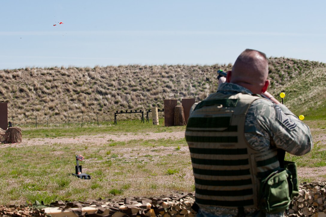 Chief Master Sgt. Eric Molloy, 28th Security Forces Squadron manager, shoots a clay pigeon with a shotgun during a shooting competition during Police Week at Ellsworth Air Force Base, S.D., May 14, 2012. Each year during National Police Week, law agencies across the nation recognize the efforts of all law enforcement professionals, past and present, by hosting events within their communities. (U.S. Air Force photo by Airman 1st Class Kate Thornton/Released)