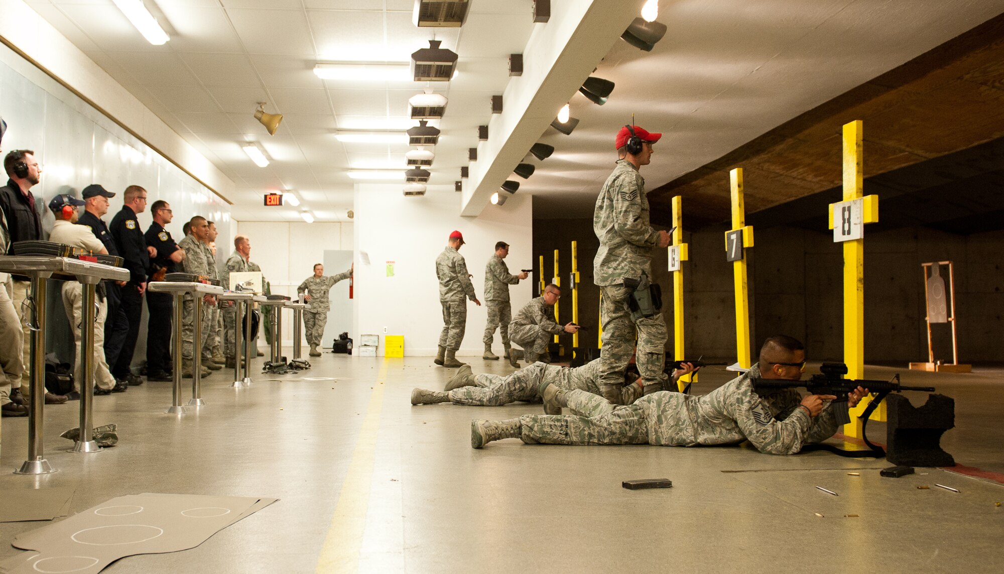 Ellsworth Airmen compete in a shooting competition during Police Week at Ellsworth Air Force Base, S.D., May 14, 2012. Various organizations on base put together three-member teams to evaluate their shooting skills by using a 12-gauge shotgun, M-9 pistol and an M-4 rifle in a variety of obstacles and firing positions. (U.S. Air Force photo by Airman 1st Class Kate Thornton/Released) 