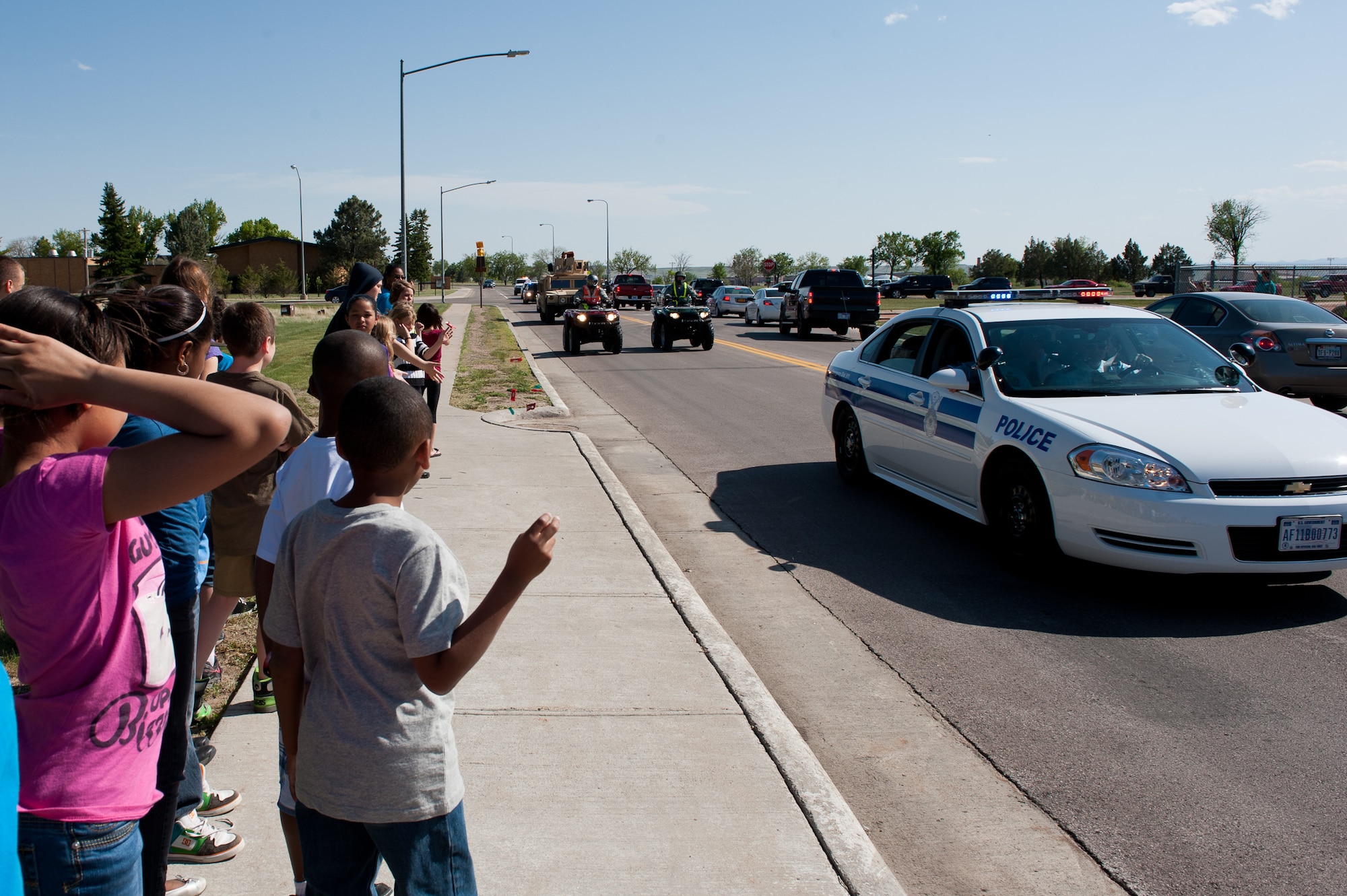 Airmen of the 28th Security Forces Squadron toss candy to children during a parade for National Police Week at Ellsworth Air Force Base, S.D., May 14, 2012. Defenders assigned to the 28th SFS organized a variety of activities and events as part of National Police Week May 12 to 16. These special events recognize the efforts of all law enforcement professionals. (U.S. Air Force photo by Airman 1st Class Kate Thornton/Released)