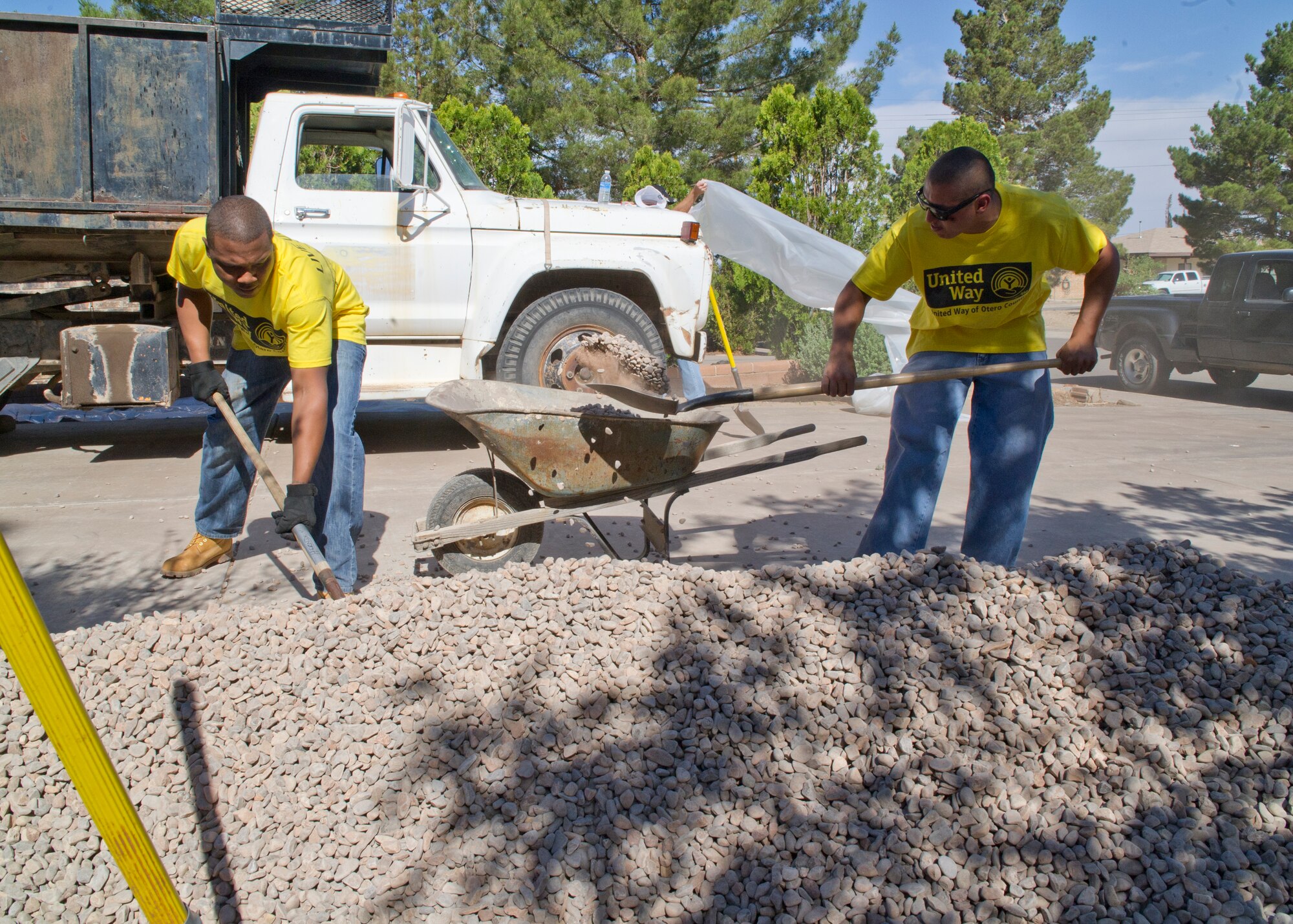 ALAMOGORDO, N.M. – Senior Airman Marshall Thompson and Airman 1st Class Jose DeSantiago, both 49th Logistics Readiness Squadron petroleum, oils and lubricants technicians, shovel rocks into a wheel barrow May 18 for a local citizen during the Day of Caring. Members from every flight of the 49th LRS were volunteering for the Otero County United Way event, which is designed to assist the local community and community members in need. More than 500 Team Holloman members volunteered for this year’s Day of Caring event. (U.S. Air Force photo by Airman 1st Class Siuta B. Ika/Released)