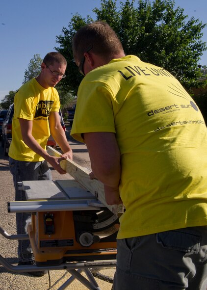 ALAMOGORDO, N.M. – Senior Airmen Justin Boyce and Chris Kirton cut a piece of wood May 18 for a local citizen during the Day of Caring. More than 500 Team Holloman members volunteered for the annual Day of Caring, which is hosted by the Otero County United Way. Boyce is a heating ventilation and air conditioning technician with the 49th Civil Engineer Squadron and Kirton works in the 49th CES structures shop. (U.S. Air Force photo by Airman 1st Class Siuta B. Ika/Released)