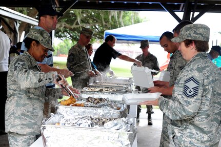 Chief Master Sergeants serve food during the Chiefs Annual Fish Fry, May 18 at Joint Base Charleston - Air Base, S.C.  The fish fry began as a barbeque in 1987 and was a way to unite the Reserve and active-duty members on the air base. (U.S. Air Force photo/ Staff Sgt. Nicole Mickle)  