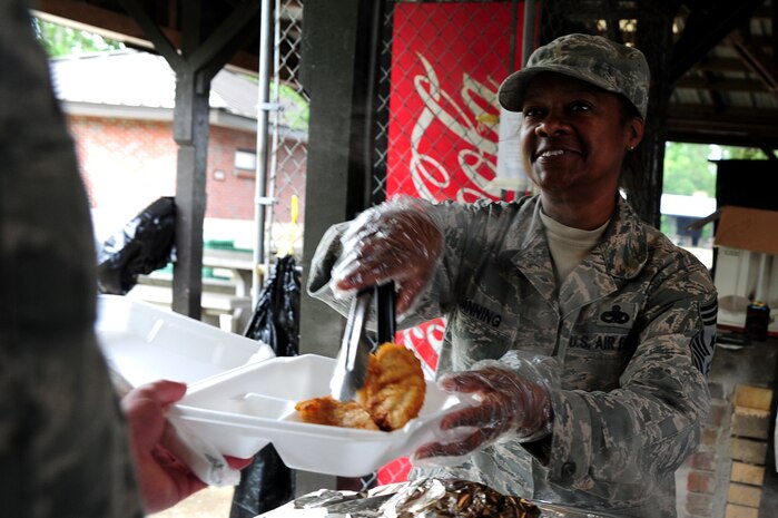 Chief Master Sgt. Gigi Manning, command chief of the 315th Airlift Wing, serves fish at the Chiefs Annual Fish Fry, May 18 on Joint Base Charleston - Air base, S.C.  The fish fry began as a barbeque in 1987 and was a way to unite the Reserve and active-duty members on the air base.  (U.S. Air Force photo/ Staff Sgt. Nicole Mickle)
 
