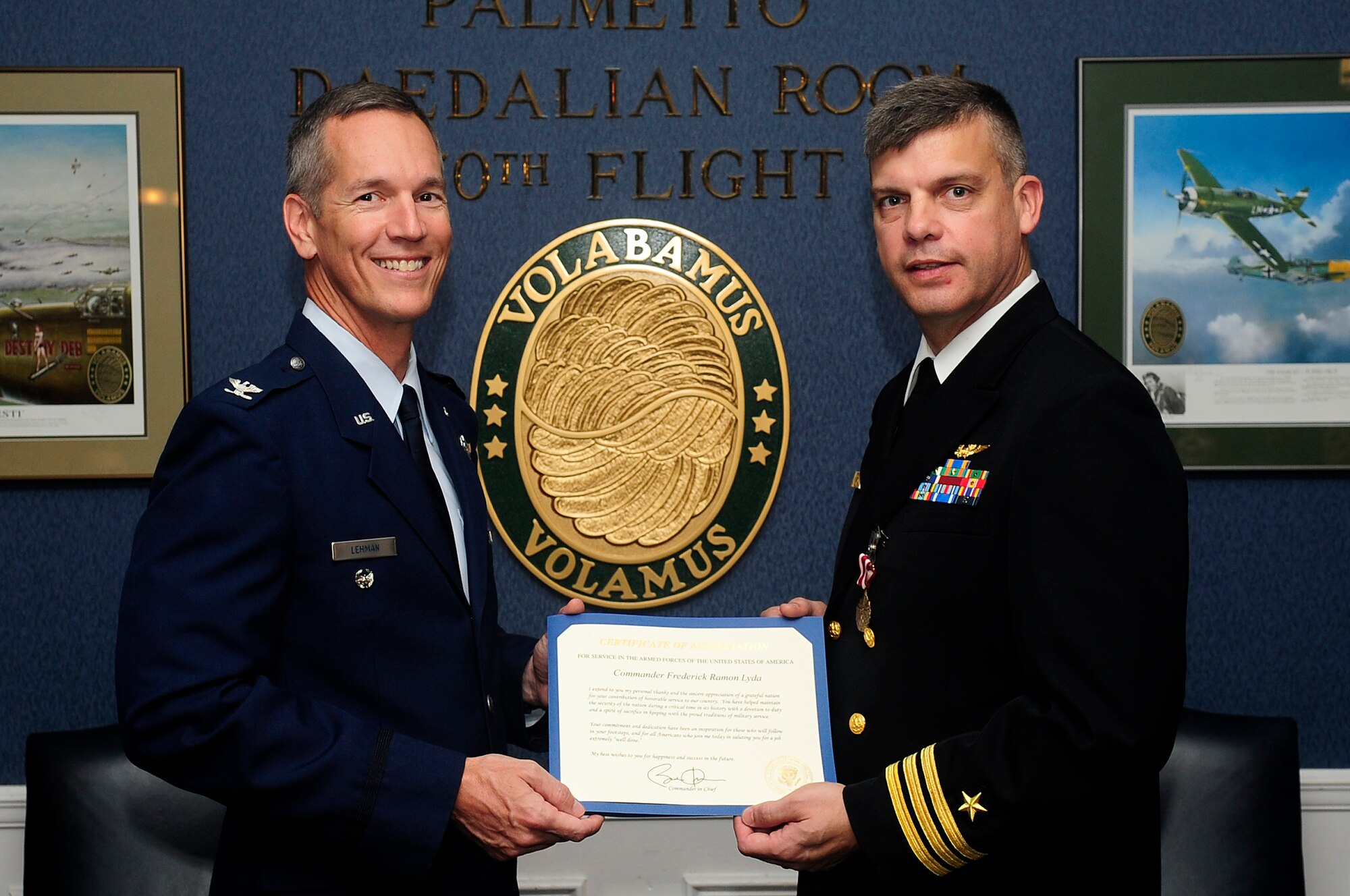 U.S. Navy Cmdr. Fred Lyda, Air Force Central Command chief of current operational plans (right), retires from active duty at Shaw Air Force Base, S.C., May 18, 2012. (U.S. Air Force photo by Airman 1st Class Hunter Brady/Released)