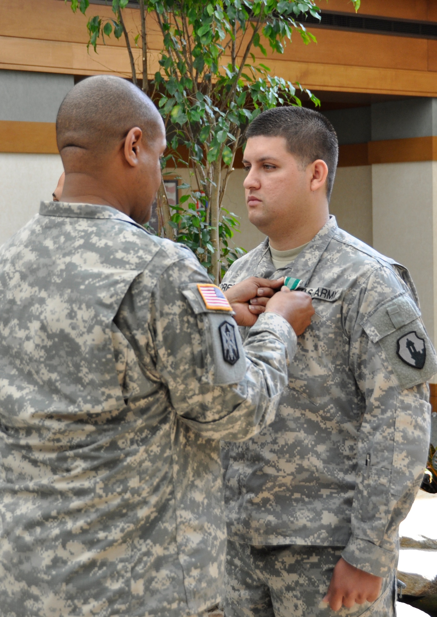 Army Sgt. Jose Crespo is awarded the Army Commendation Medal in a ceremony at the Charles C. Carson Center for Mortuary Affairs May 17, 2012. Crespo served as part of the Army Liaison Team as a member of the Casualty and Mortuary Affairs Operations Center, U.S. Army Human Resources Command, located at Fort Knox, Ky. (U.S. Air Force photo/Christin Michaud) 