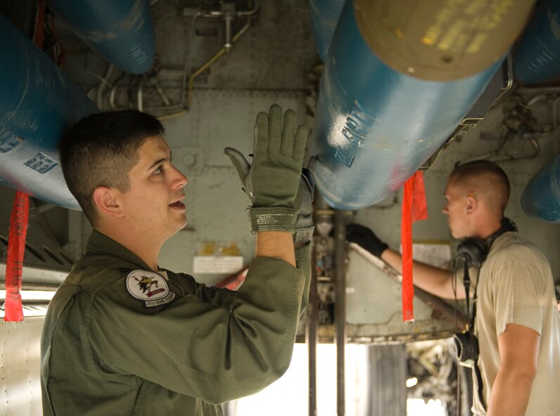 Capt. Nate Barnhart, 20th Bomb Squadron radar navigator instructor, inspects an inert 500-pound BDU-50 inside the bomb bay of a B-52H Stratofortress on Barksdale Air Force Base, La., May 17. Each member of the aircrew has his or her own specific items they check when conducting aircraft inspections before takeoff. (U.S. Air Force photo/Airman 1st Class Benjamin Gonsier)(RELEASED)