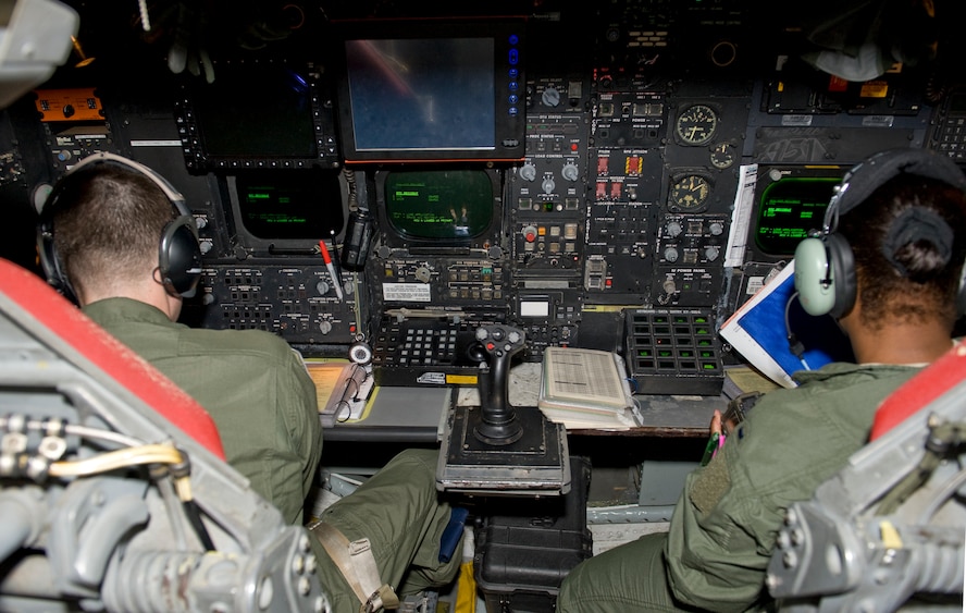 A radar navigator and navigator sit side-by-side inside the lower deck of a B-52H Stratofortress on Barksdale Air Force Base, La., May 17. The radar navigator sits on the left and ensures the proper weapons hit the targets on time. The navigator mans the right seat and is responsible for pacing the aircrew during the flight. (U.S. Air Force photo/Airman 1st Class Benjamin Gonsier)(RELEASED)