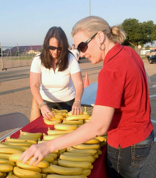 Melissa Couch and Heather Dudley, local vendors, lay out bananas for participants of the Fun Run on Barksdale Air Force Base, La., May 18. The Fun Run was held to kick off the upcoming 101 Critical Days of Summer at Barksdale. Bananas contain potassium, which can help alleviate runner's cramps. (U.S. Air Force photo/Senior Airman Kristin High)(RELEASED)