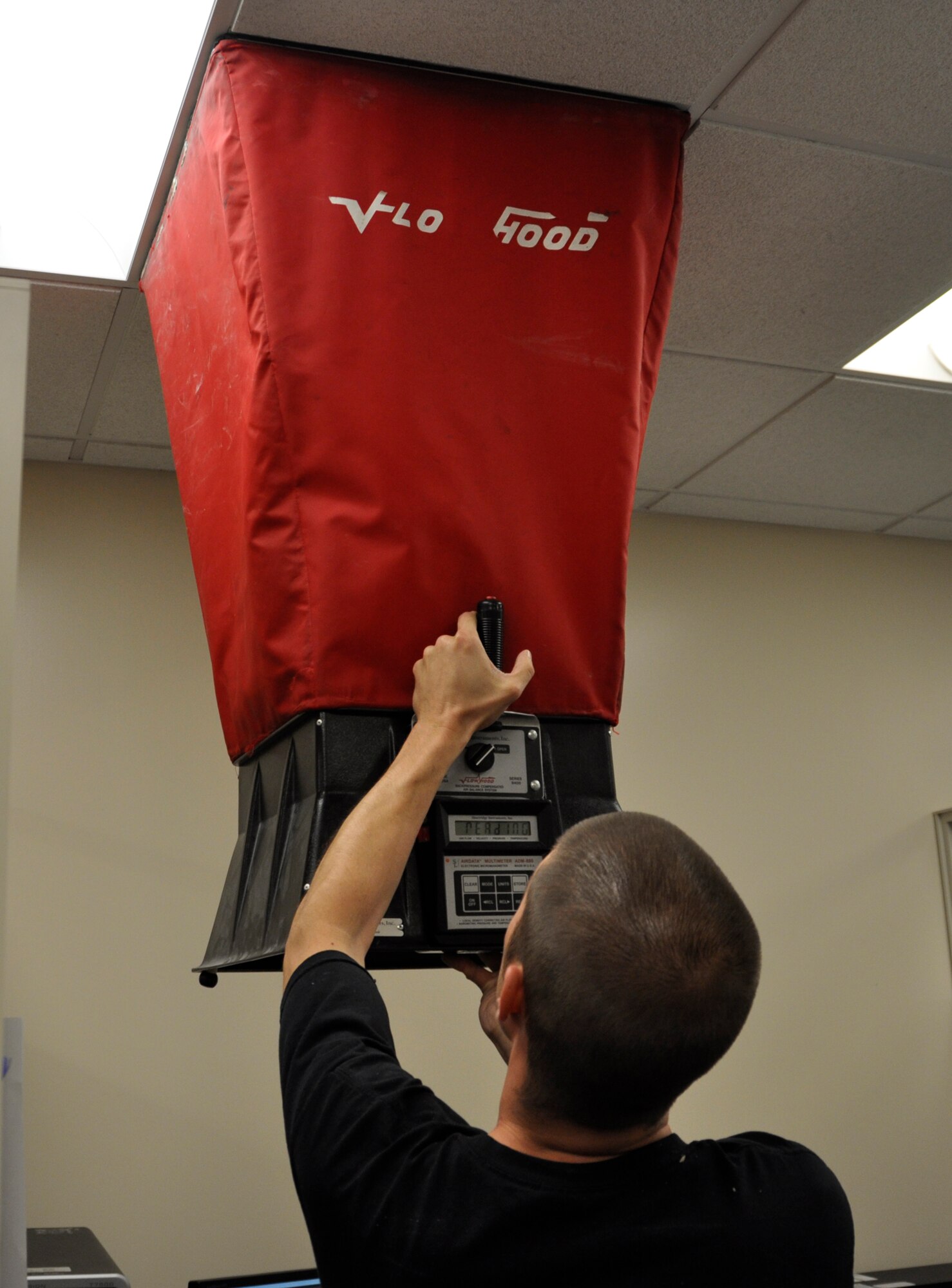Will Crosgrove, Chesapeake Testing and Balancing, takes a reading with a flow hood May 15, 2012 at the Charles C. Carson Center for Mortuary Affairs. The goal is to balance the flow of air in order to conserve energy. (U.S. Air Force photo/Staff Sgt. James W. Jackson) 
