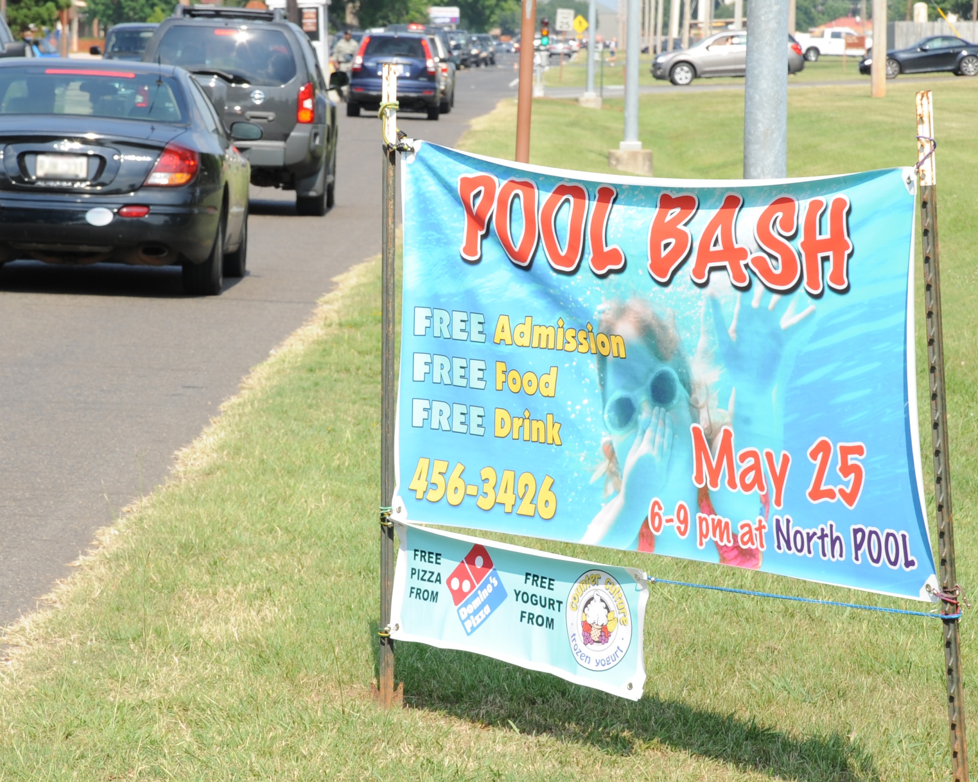 A sign near the main gate advertises the annual Pool Bash hosted by the 2nd Force Support Squadron on Barksdale Air Force Base, La., May 17. The Pool Bash will be held May 25 at the North Pool and will feature free food, drinks and admission for Team Barksdale members. The event signifies the pool's opening for the summer season. (U.S. Air Force photo/Senior Airman Sean Martin) (RELEASED)