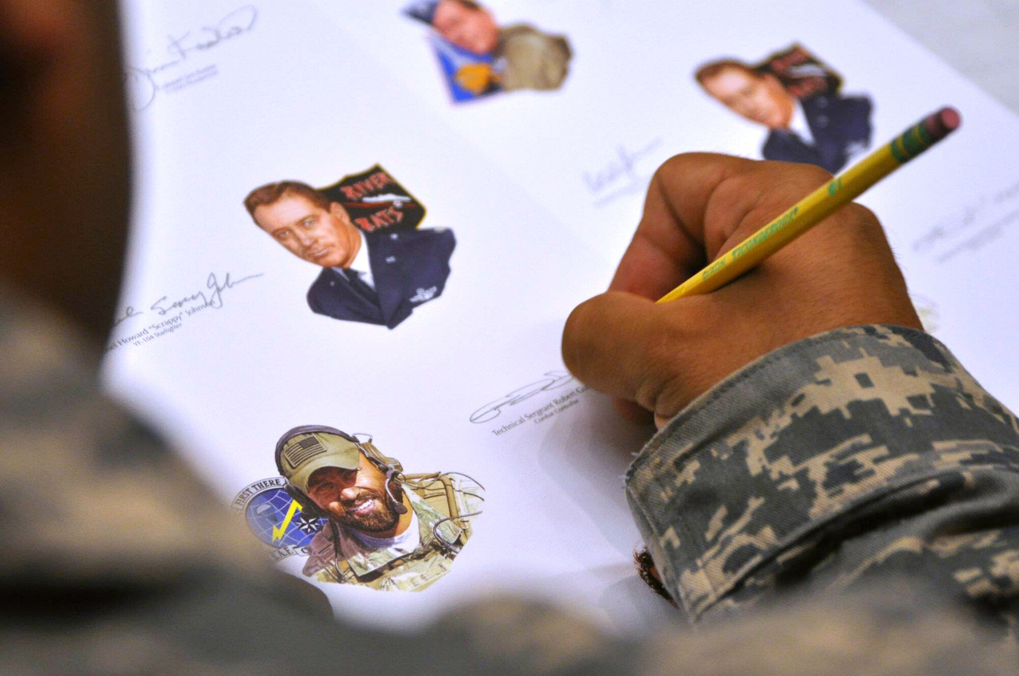 Tech. Sgt. Robert Gutierrez, Special Tactics Training Squadron instructor, signed hundreds of Gathering of Eagles lithographs at Hurlburt Field Fla., May 17. Gutierrez, a recipient of the Air Force Cross. is the only active duty, enlisted Airman to be part of annual program that promotes air power lessons through first-hand experiences. He will join other legends such as prisoners of war and a Tuskegee Airman in June to share his story of resiliency at Maxwell Air Force Base's Air Command and Staff College.  (U. S. Air Force photo by Ashley M. Wright) 