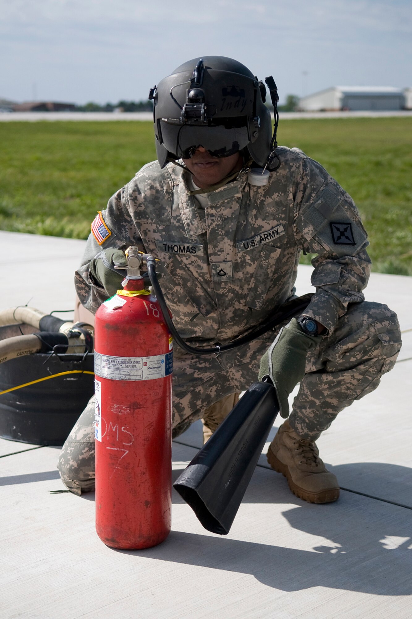 GRISSOM AIR RESERVE BASE, Ind. -- Kentucky Army National Guard Private 1st Class Junia Thomas, 2-238th General Support Aviation Battalion Medical Evacuation Unit aviation refueler, stands watch with a fire extinguisher as his team refuels a UH-60 Black Hawk here April 24. The 2-238th MEDEVAC, a unit made of Indiana and Kentucky National Guardsmen, trained two weeks at Grissom for an upcoming deployment to Southwest Asia. (U.S. Air Force photo/Tech. Sgt. Mark R. W. Orders-Woempner)
