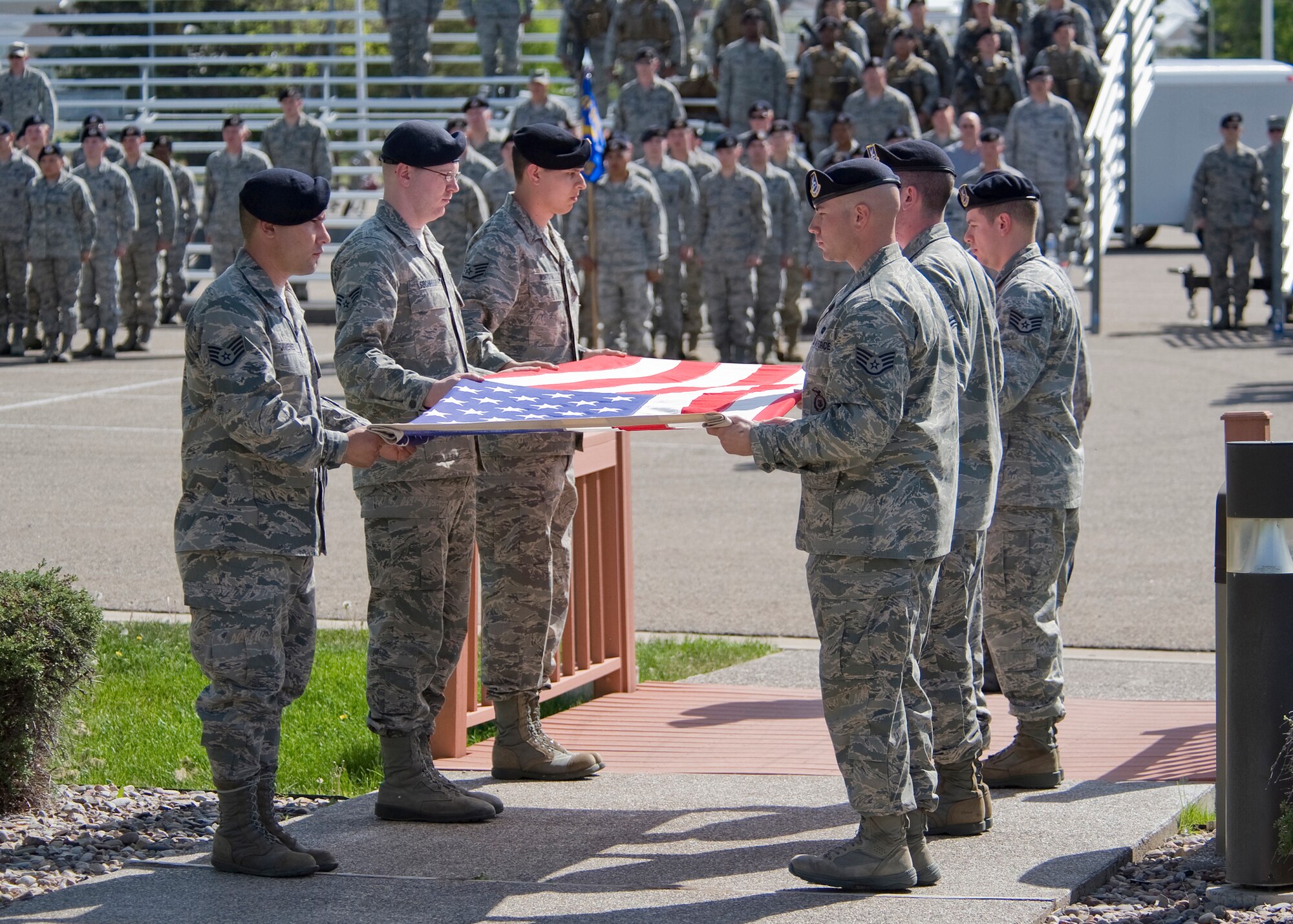 A six-person Security Forces detail prepares to fold the flag during a retreat ceremony May 15 in honor of Police Week activites at Malmstrom. (U.S. Air Force photo/Beau Wade)