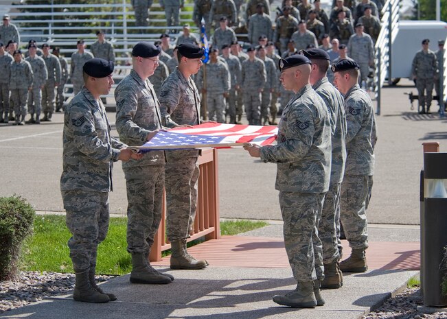 A six-person Security Forces detail prepares to fold the flag during a retreat ceremony May 15 in honor of Police Week activites at Malmstrom. (U.S. Air Force photo/Beau Wade)