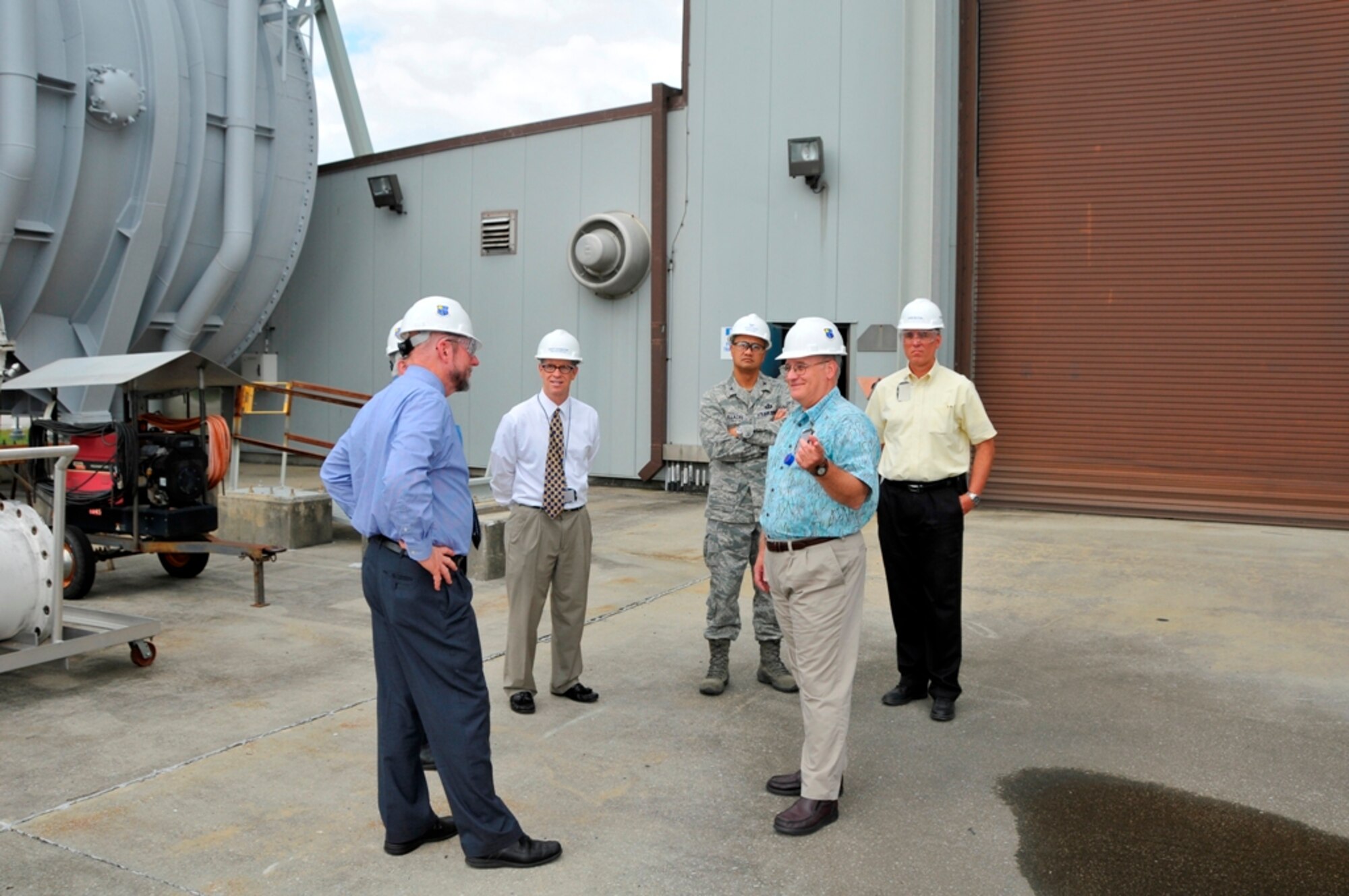 From left, – Dr. Davy Belk, AFFTC’s executive director at Edwards AFB, Chris Smith, AEDC’s technical director of the Space and Missile Ground Test Complex, Britt Covington, AEDC executive director, and Col. Geoffrey Ellazar, Jr, AFFTC director of contracting, listen as Randy Quinn, Rocket Test capability manager, explains the role of the exhauster for the Rocket Development Test Cell J-6 Facility. (Far right) John Sutton, AEDC’s director of contracting, said their visitors were onsite to learn more about AEDC’s award fee determination process.